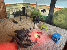 A meerkat enclosure with the walls painted with African scenery but no people